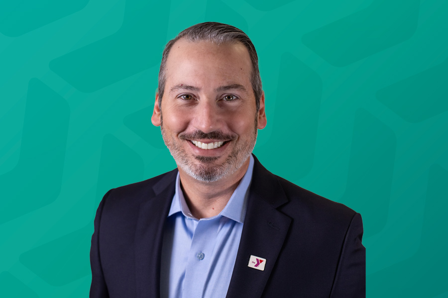 Photo of Daniel Saginario in front of green chevron background