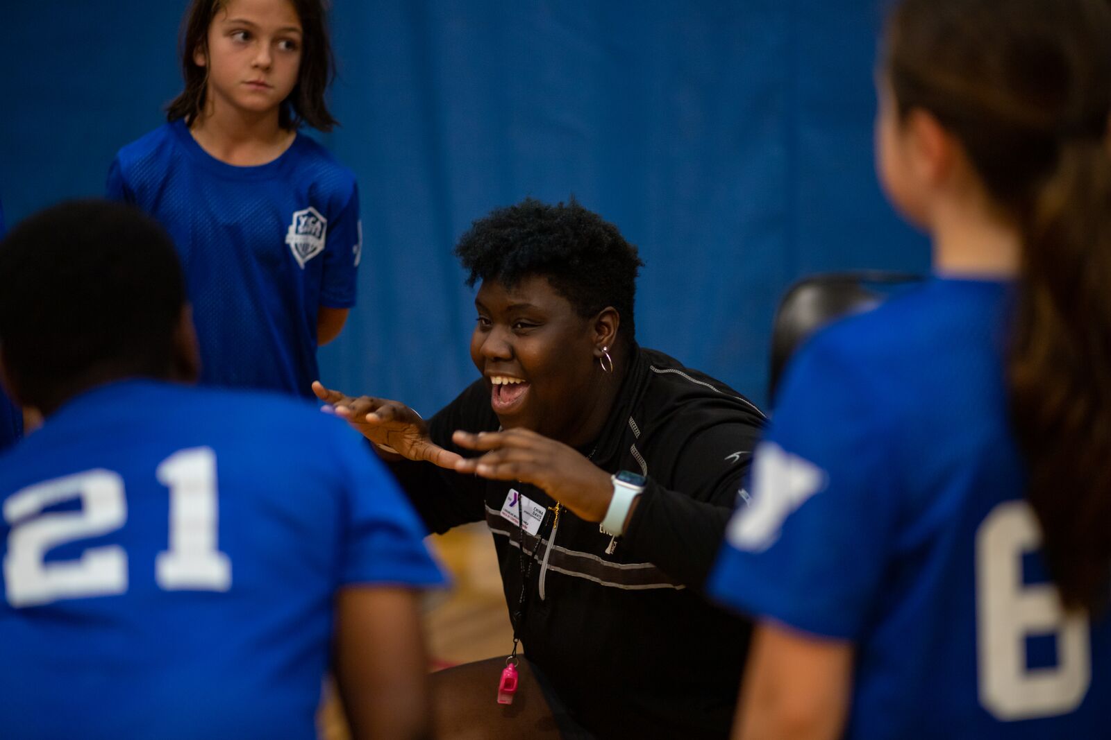 Woman coach cheering on her volleyball players