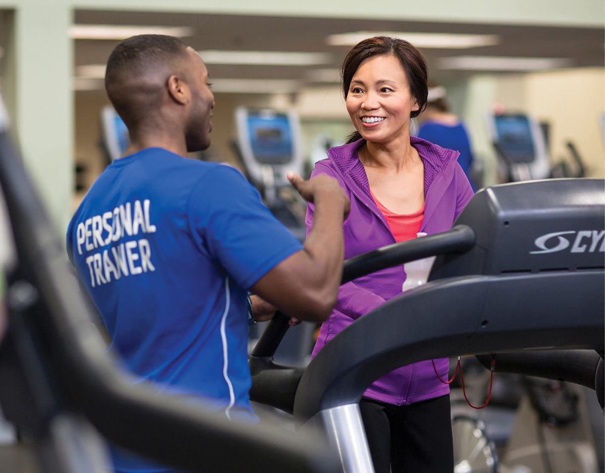 Male YMCA Personal Trainer with Female Member on Treadmill