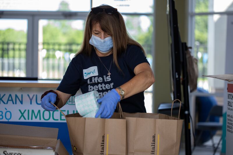Volunteer Packing Supplies for Food Distribution